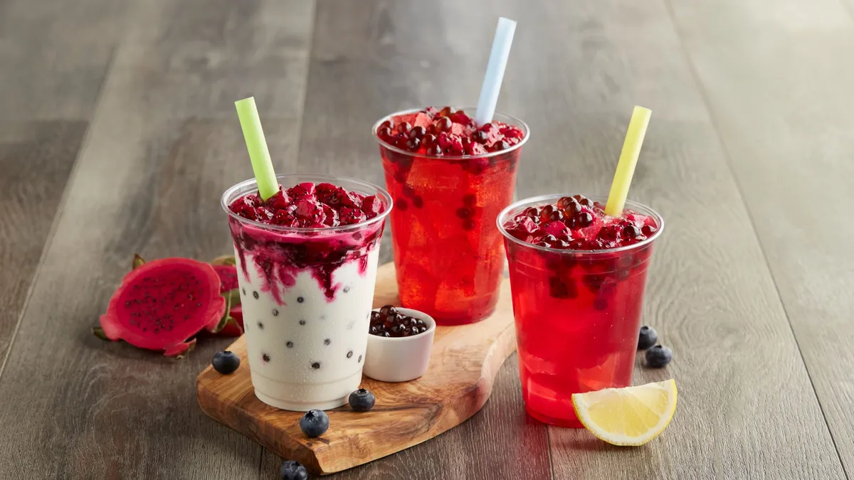 Three fast food drinks with blueberry dragonfruit poppers.