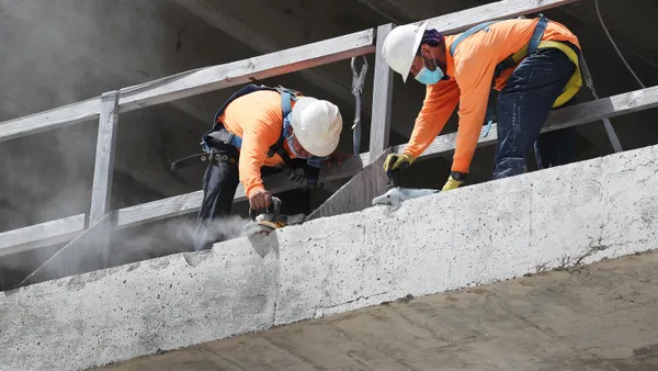 Construction workers with masks working during the COVID-19 pandemic