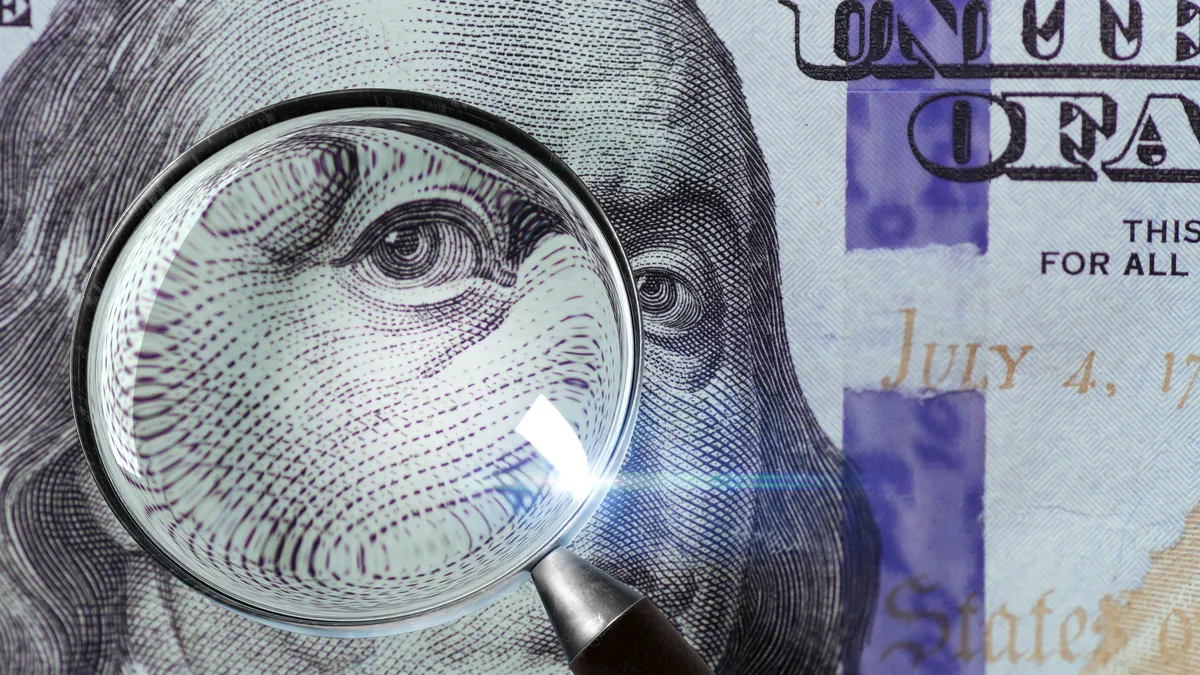 100 US Dollar under magnifying glass