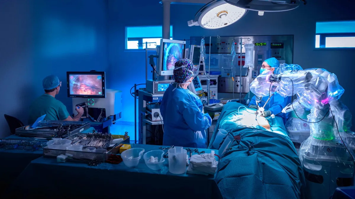 A procedure is performed in an operating room using CMR Surgical's Versius robotic system.