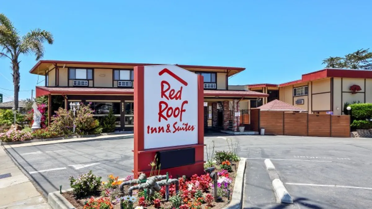 An exterior image of a hotel and signage.