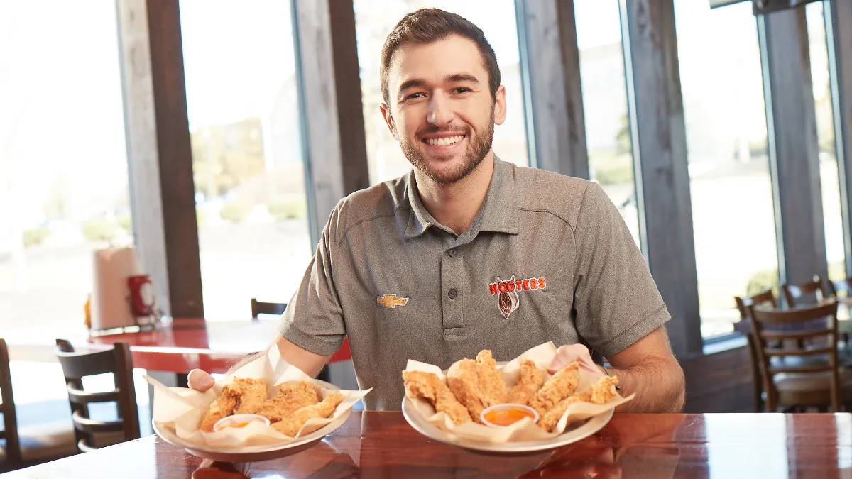 An image of Chase Elliot, Nascar racer, with chicken tenders.