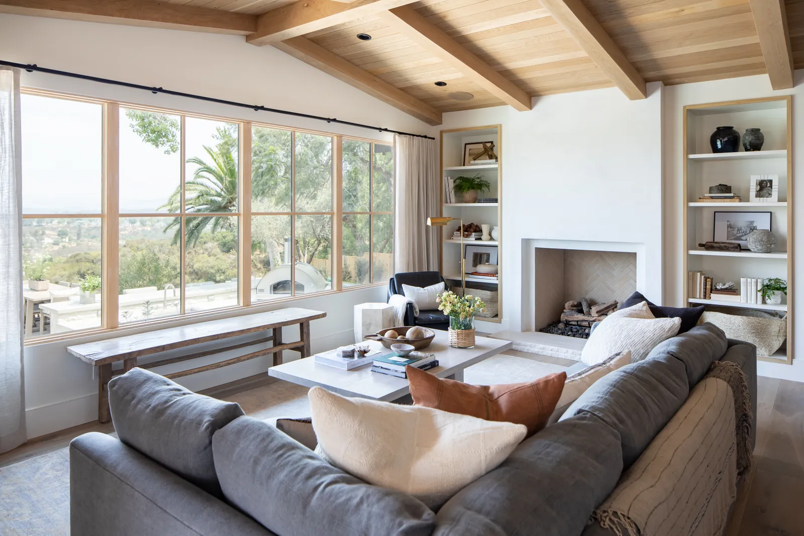 A living room with white oak windows.