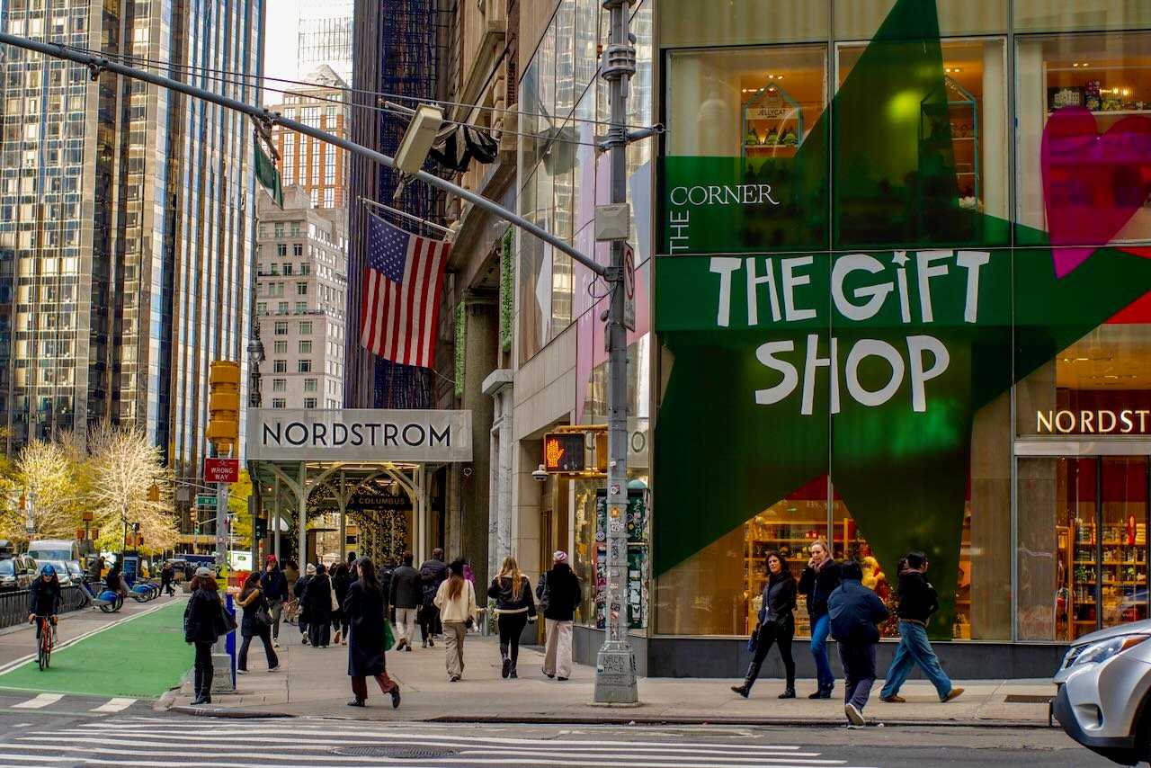 People walking around a city intersection.