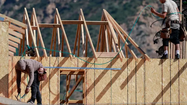 Construction workers build a home