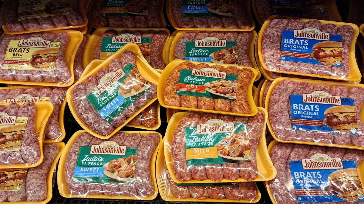 Packets of sausages with the Johnsonville label at a grocery store.