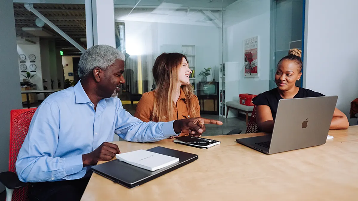 A team sitting at a meeting table discussing
