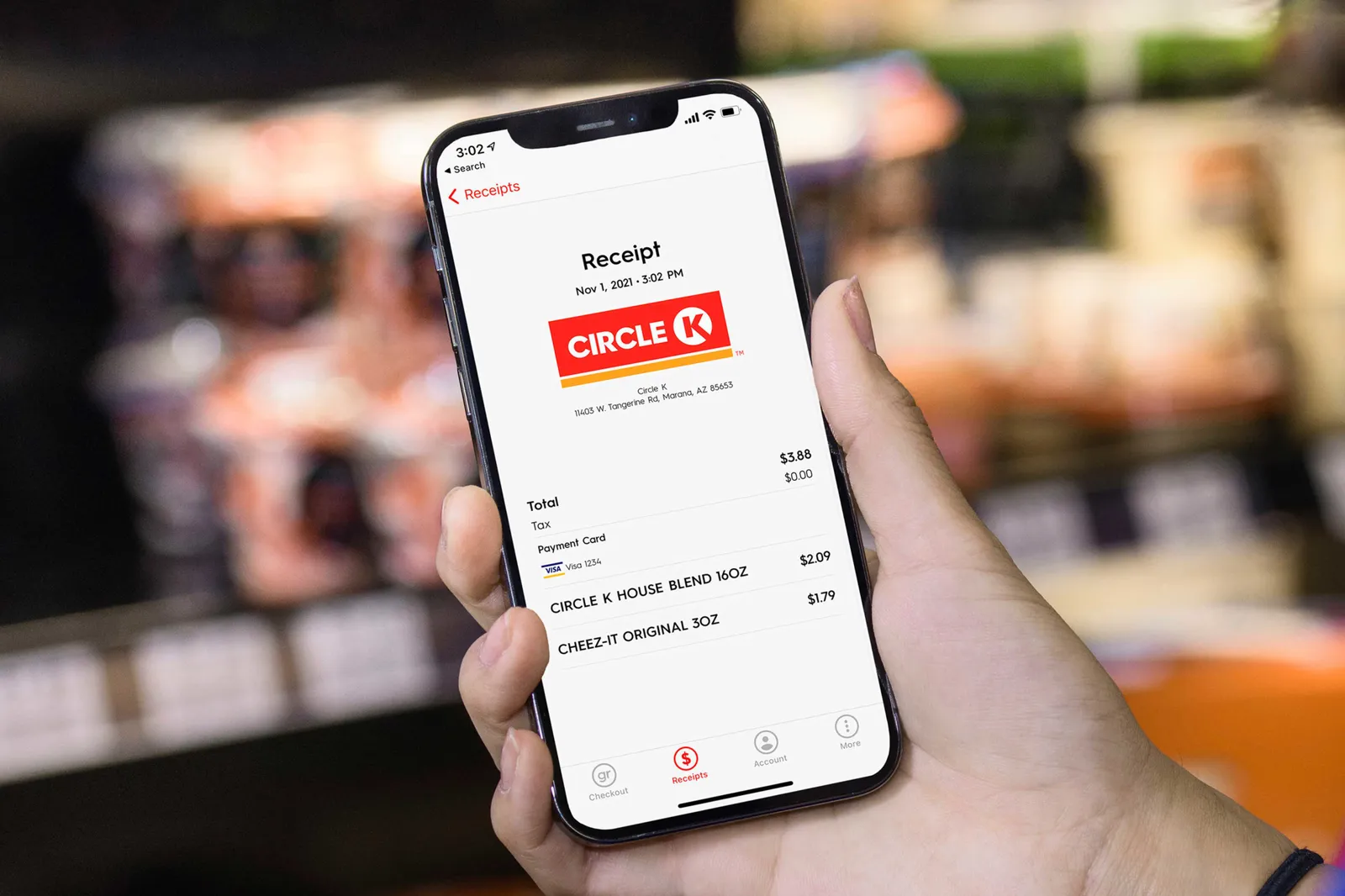 A photo of a hand holding a phone that's being used to buy items at Circle K via the Grabango technology.