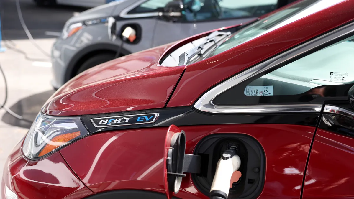 A Chevy Bolt EV plugged in at a charging station.