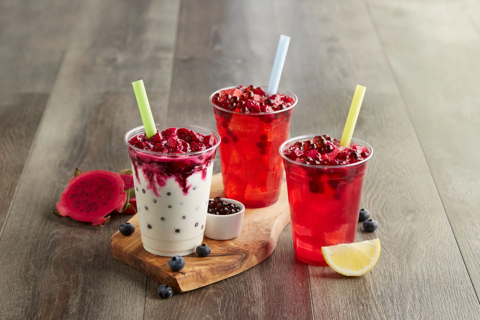 Three fast food drinks with blueberry dragonfruit poppers.