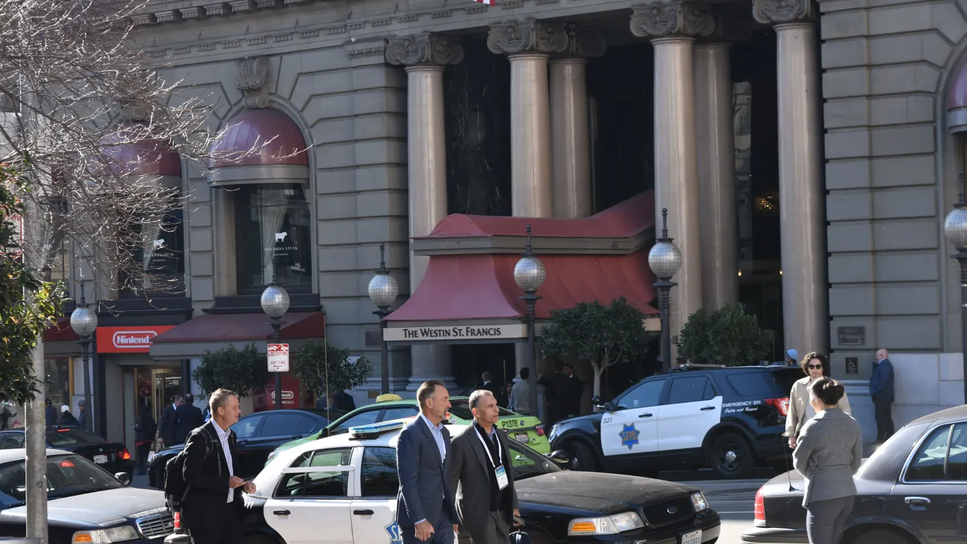 A photo of people walking in front of the Westin St. Francis Hotel in San Francisco