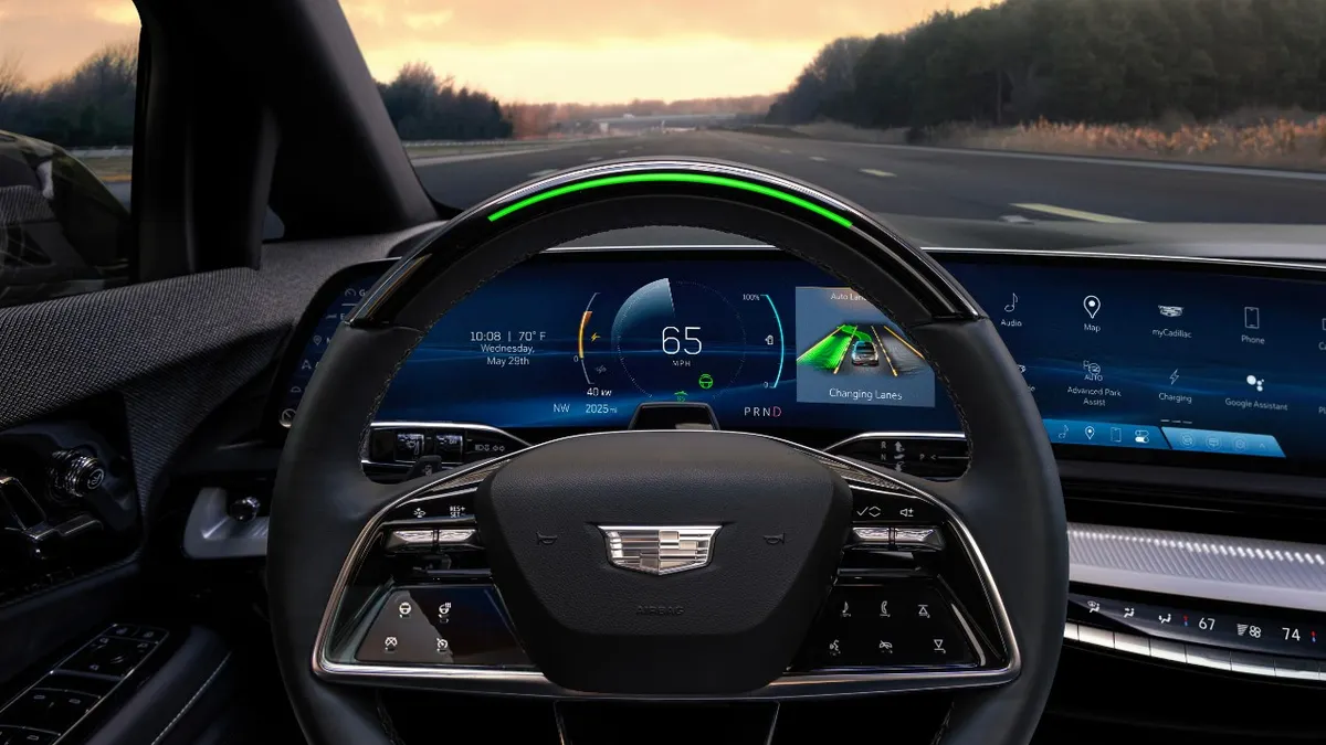The steering wheel and dashboard view from the driver seat of the Cadillac Optiq electric SUV.
