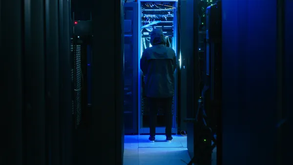 A hacker in  data center server room.