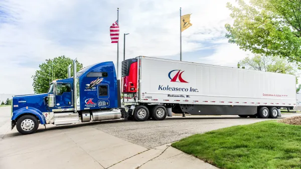 A truck with the Koleaseco name on the container of the truck.