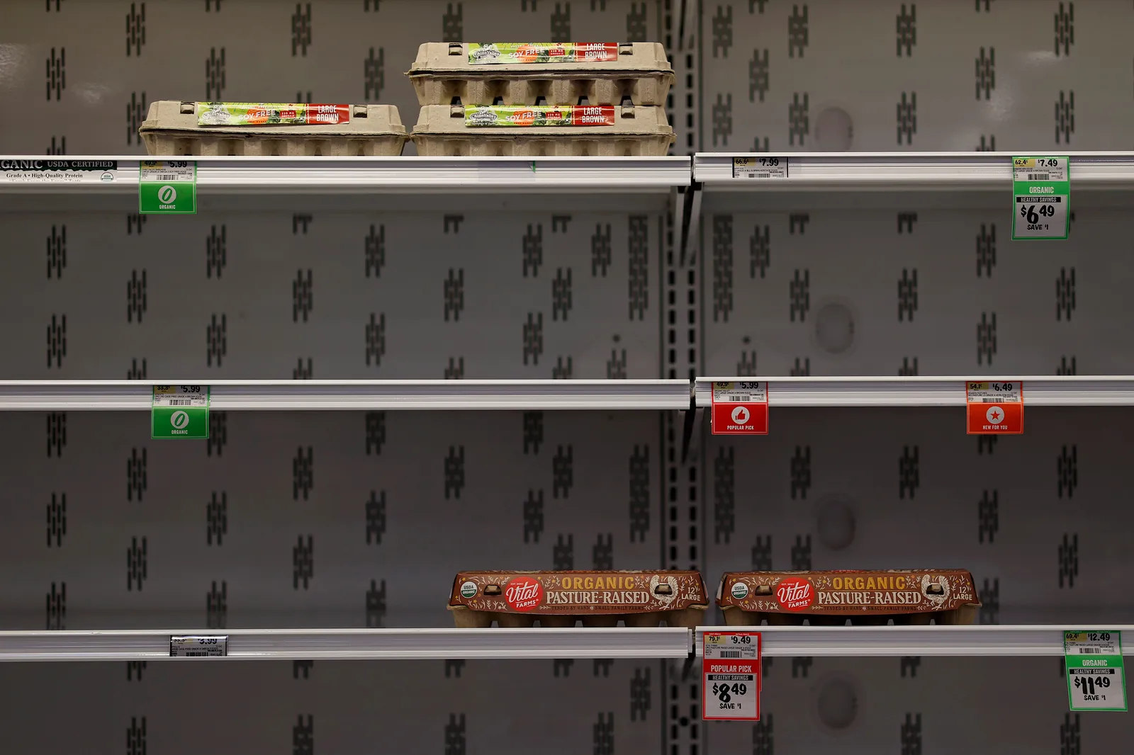 Two egg cartoons on a grocery shelf.