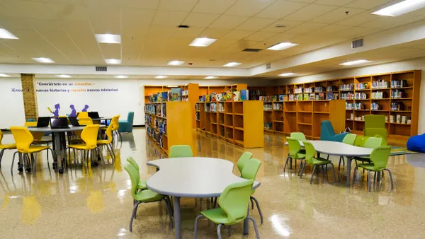 A school library as seen after a renovation with colorful chairs and bookshelves