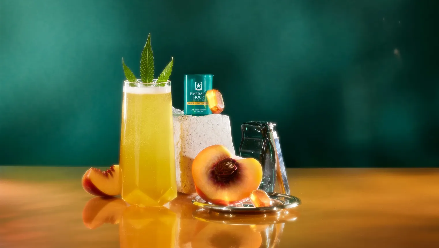 A studio shot of Emerald Hour gummies next to a cocktail and a peach.