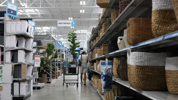 A customer shopping in an At Home store. Baskets of various colors and sizes line shelves.