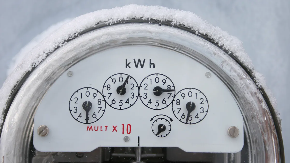 An electricity meter covered in snow.