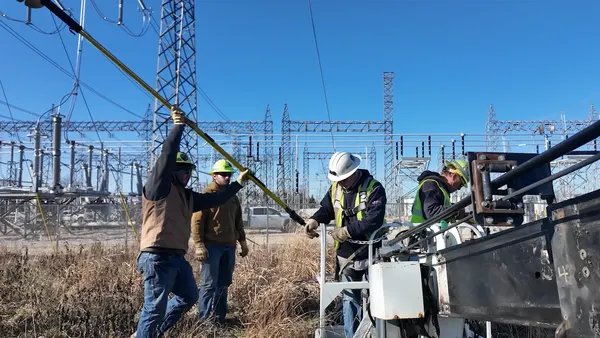 Ameren workers install Heimdall Power dynamic line rating technology on congested transmission lines.