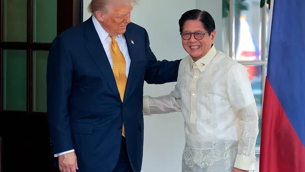 U.S. President Donald Trump greets Philippine President Ferdinand Marcos Jr. at the White House. Trump has his hand on the back of Marcos.