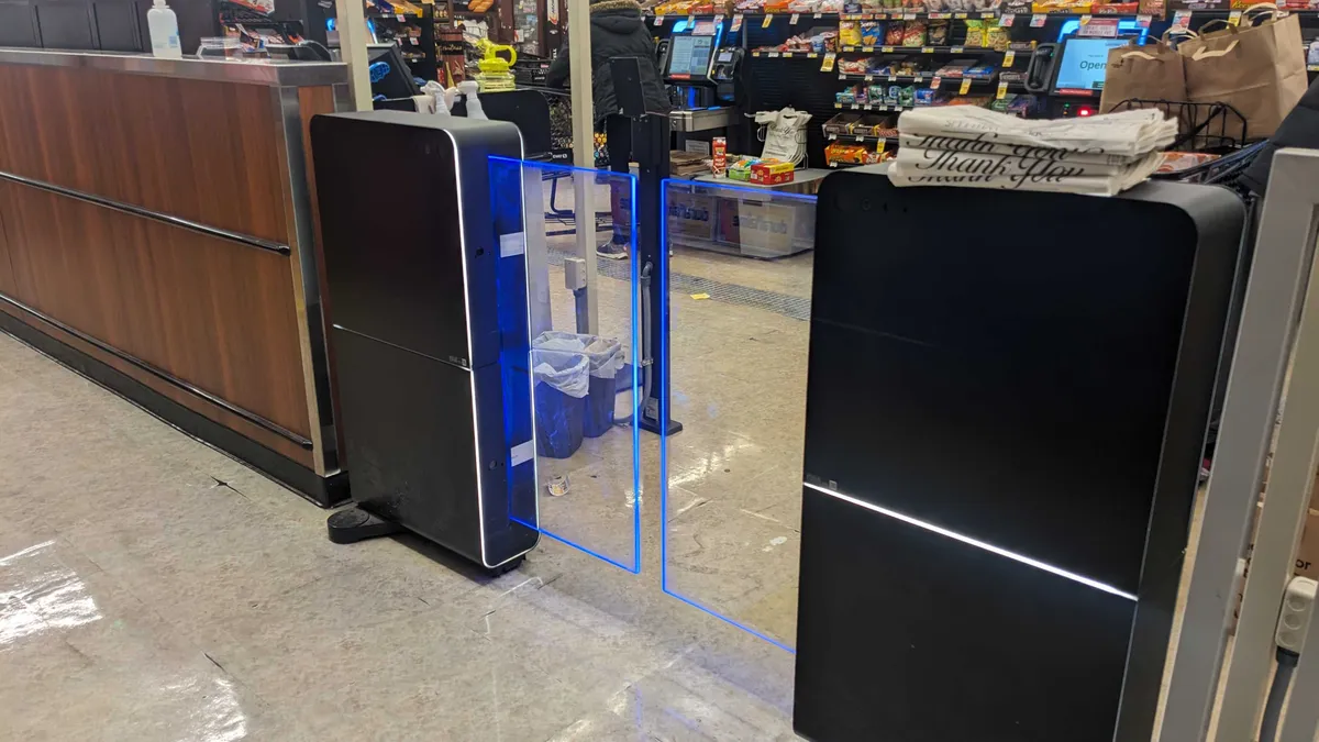 A gate with receipt scanner at a store.