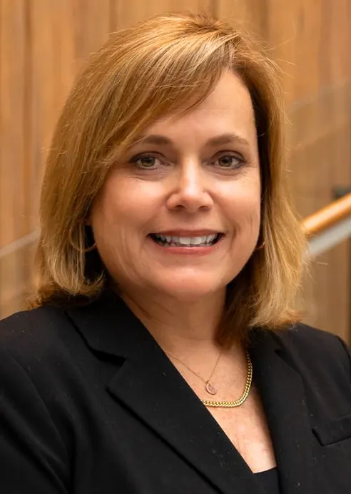 Headshot of a woman in business attire.