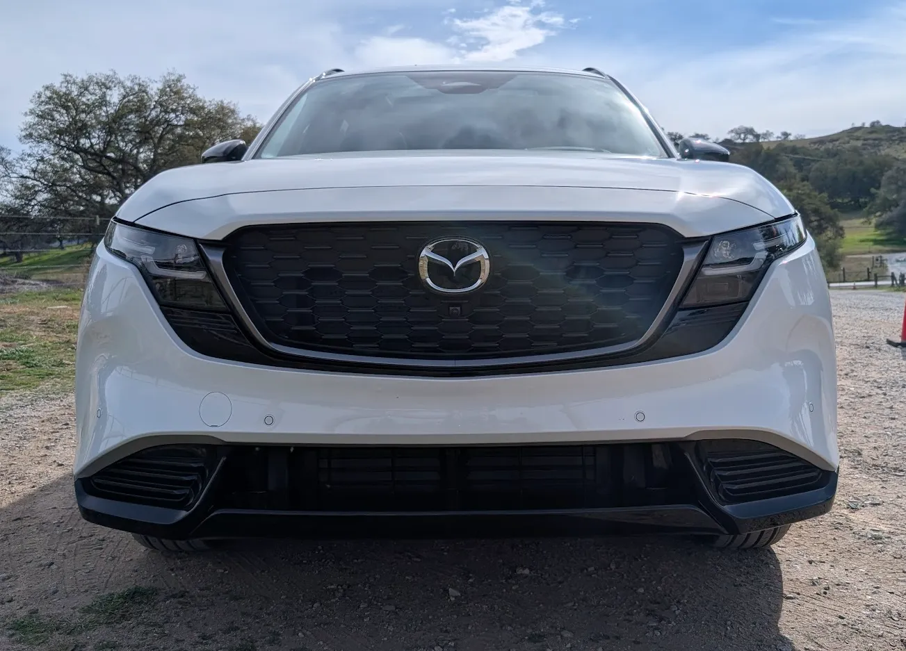 The front grill of a white 2026 Mazda CX5.
