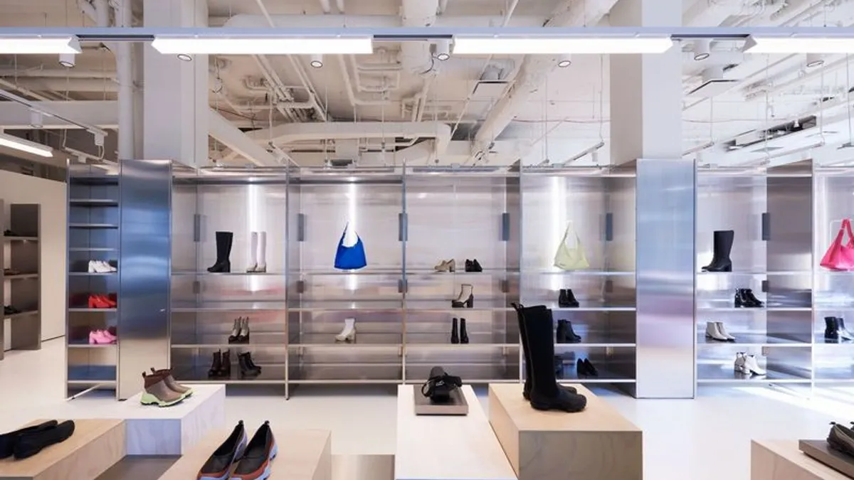 The inside of the Ecco store in SoHo with shoes and accessories on shelves and tables.