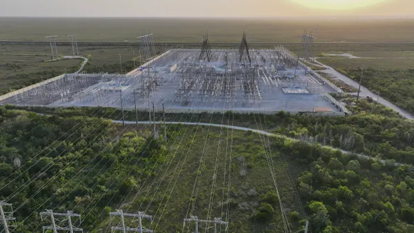 In an aerial view, high voltage power lines run along the electrical power grid on May 16, 2024, in West Palm Beach, Florida.