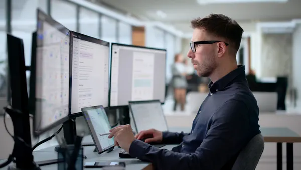 Young Software Engineer Works On Laptop