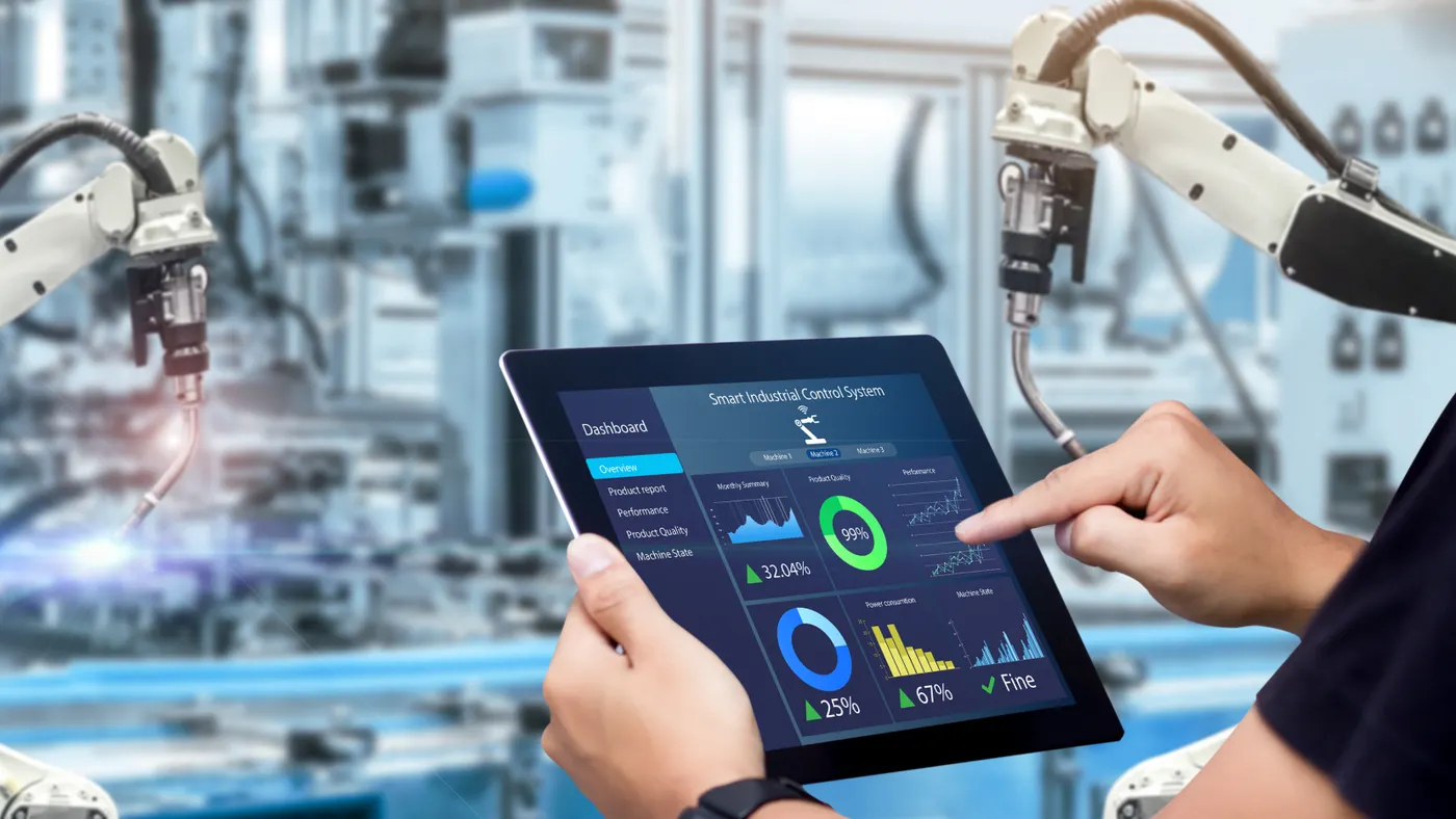 A man using the Smart Industrial Control System Dashboard on his tablet