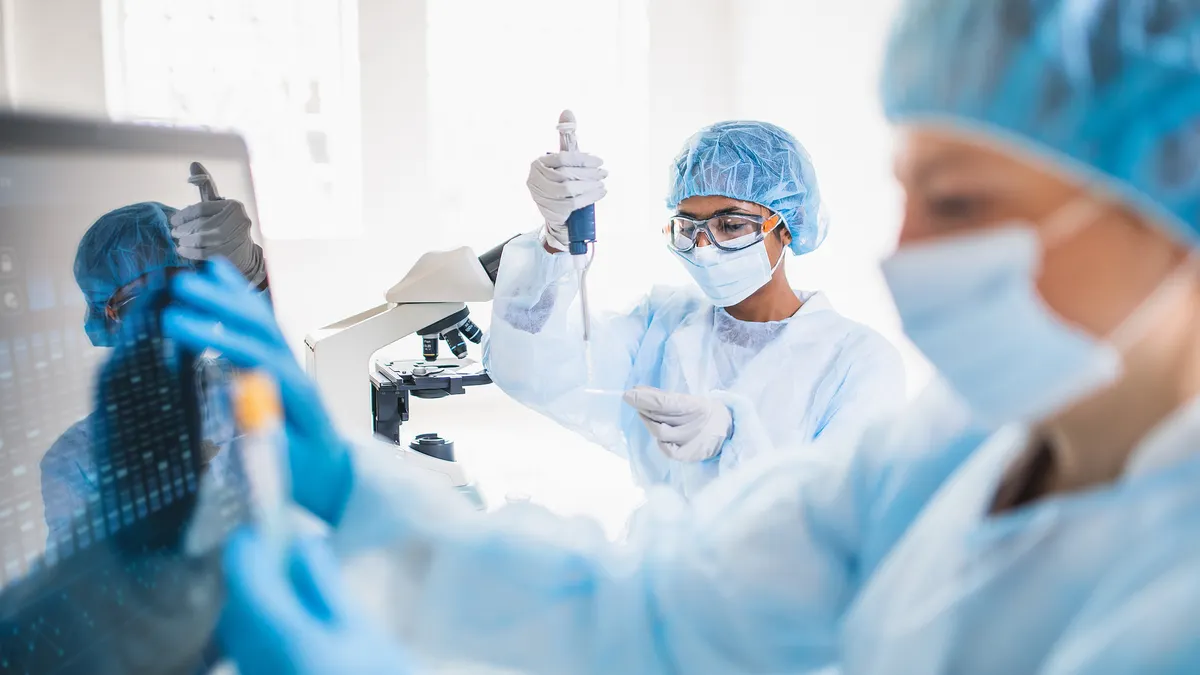 Scientists wearing full protective suit working in the laboratory