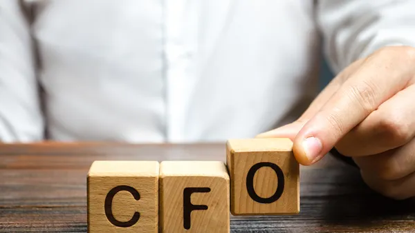 A man makes the word acronym abbreviation CFO. Chief Financial Officer. Financial management in business and company. Risk. Development and growth. Appointment to a new post, promotion.