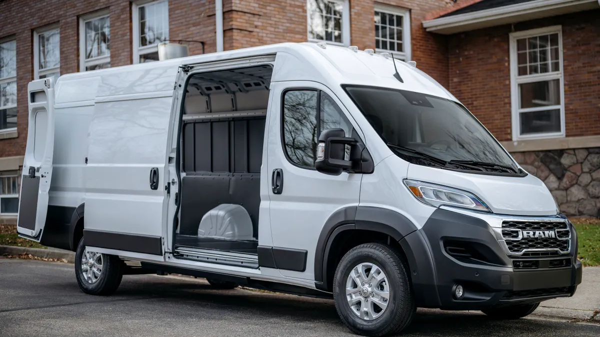 A white Ram ProMaster electric cargo van with its right side door open.