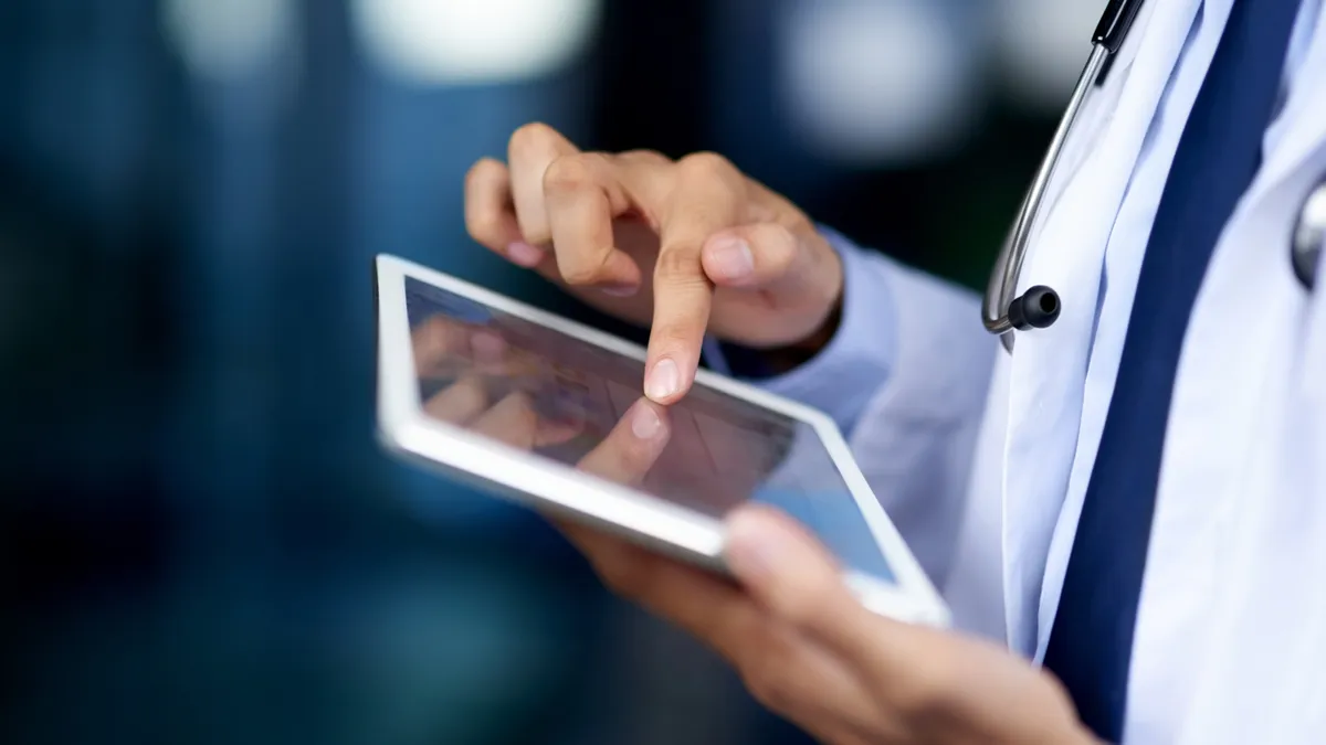 Closeup shot of an unrecognizable doctor using a digital tablet.