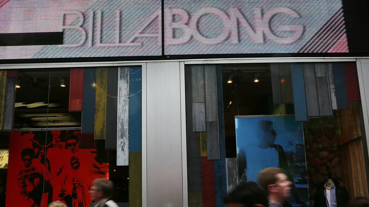 A Billabong store is pictured while people walk in front of it.