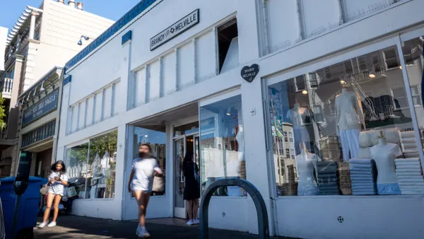 People walk in front of a Brandy Melville store.
