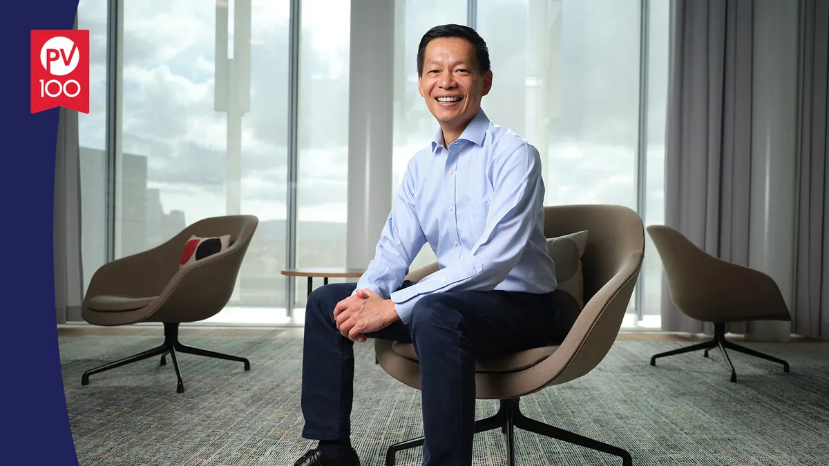 A portrait of John Tsai framed with a banner icon that reads "PV 100"