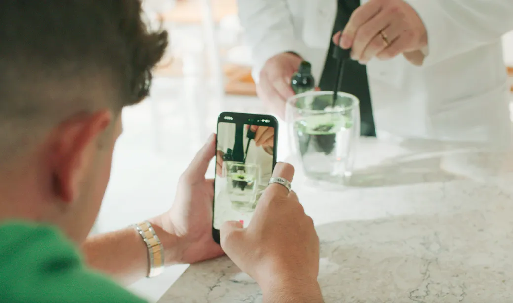 person taking photo of drink