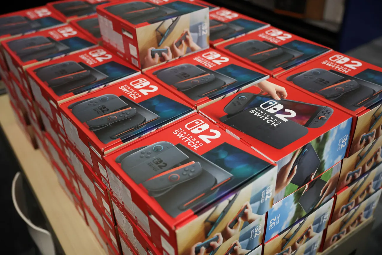 Packaged Nintendo Switch 2 consoles in boxes are displayed on a table.