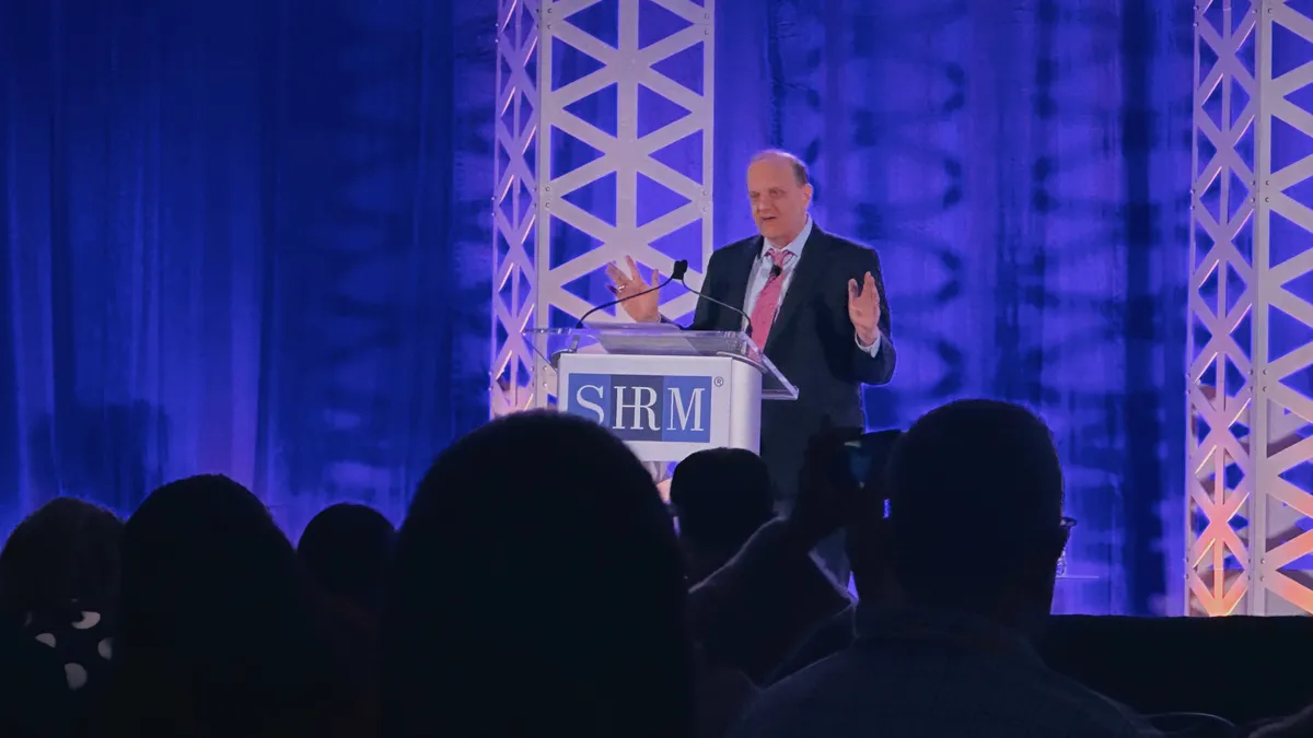 Jonathan A. Segal, an employment lawyer, stands at a podium during a 2023 conference