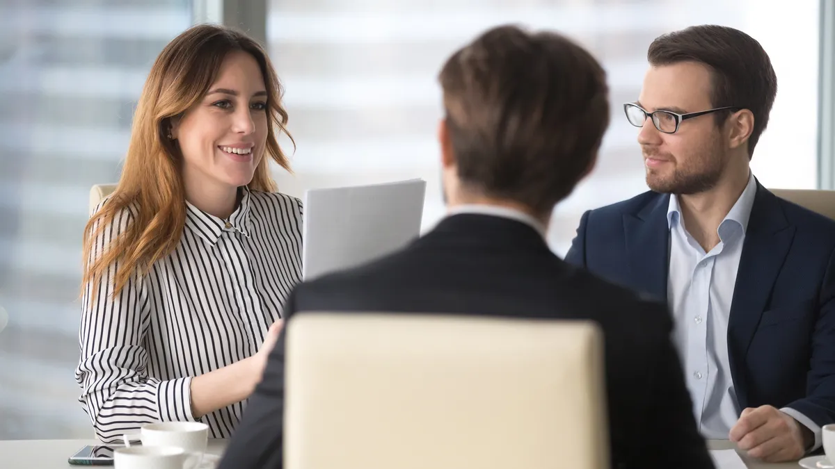 Young businesswoman talking to business partners