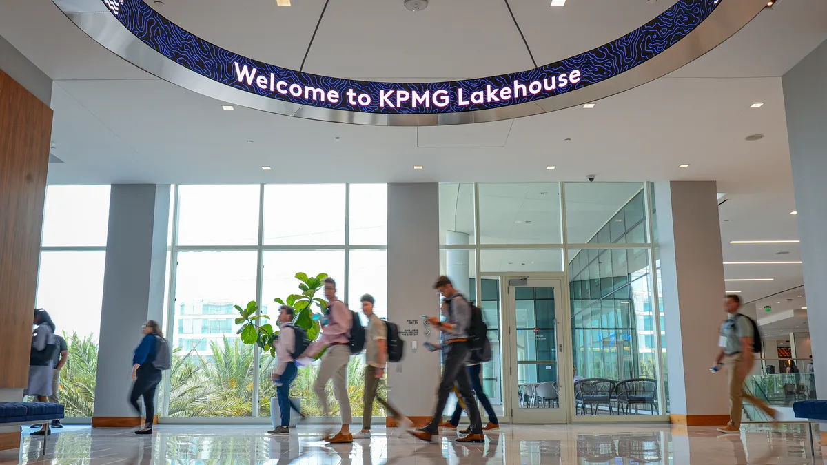 Photo of people walking through a KPMG building.