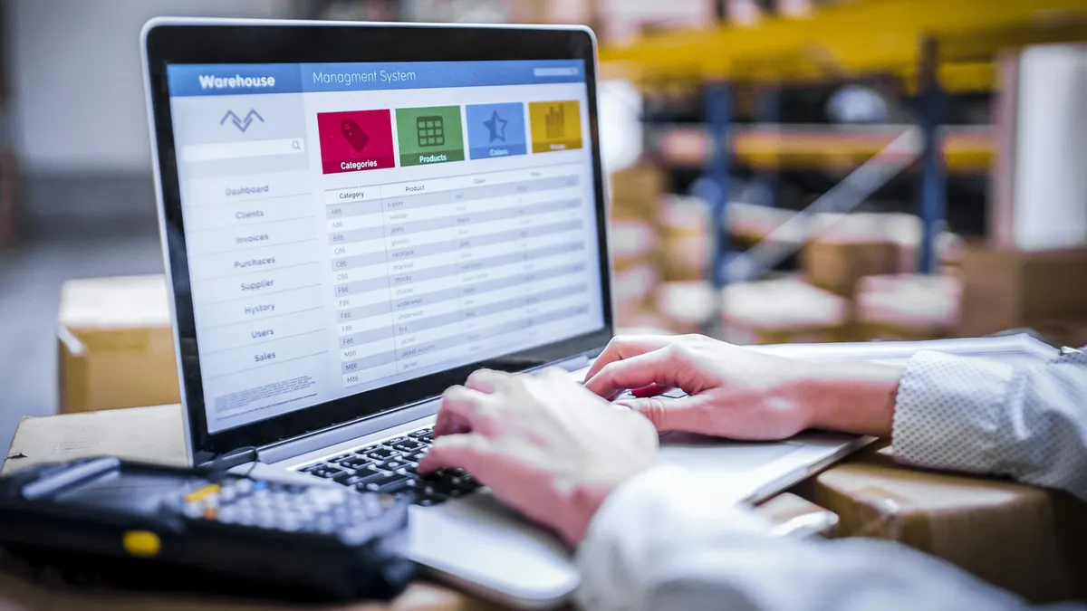 warehouse worker with a laptop in the warehouse