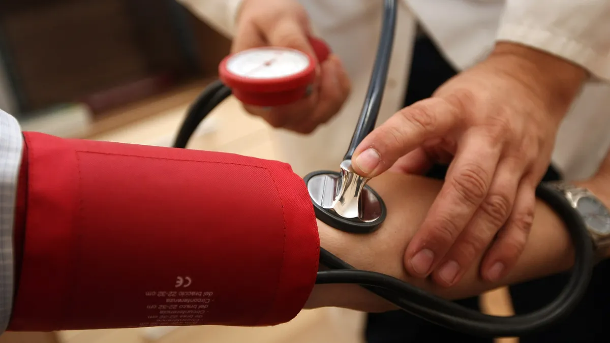 A physician taking a patient's blood pressure