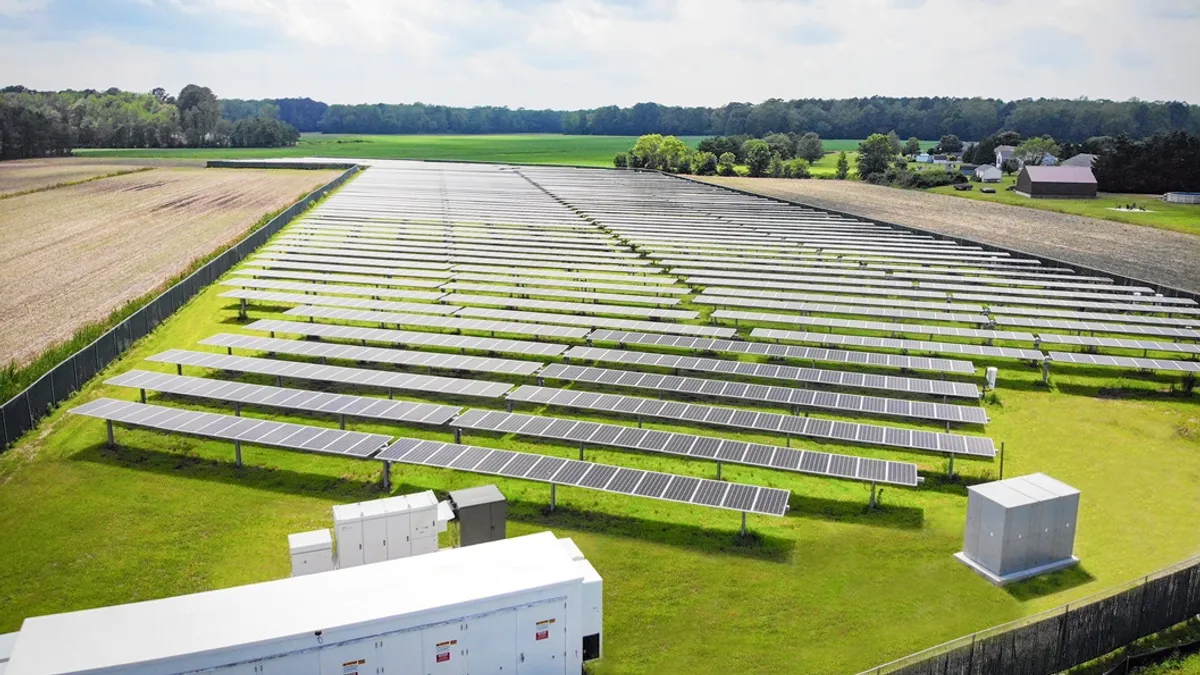 Aerial view of solar power plant under construction on green field. Assembling of electric panels for producing clean ecologic energy