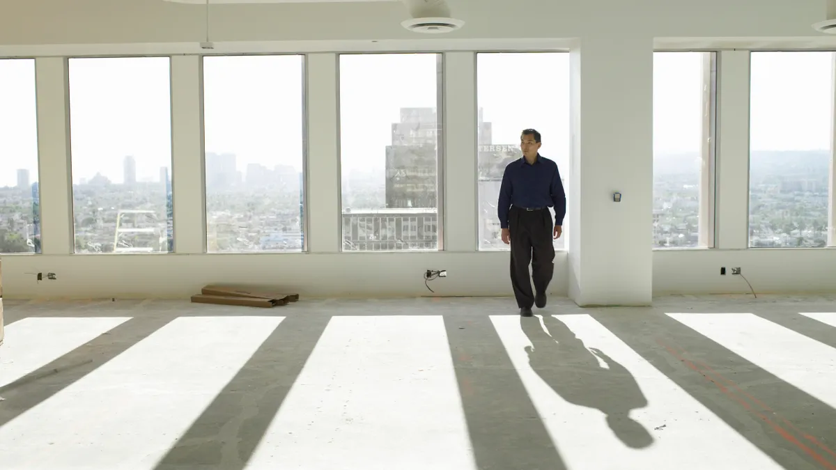 An businessperson in an empty LA office building.