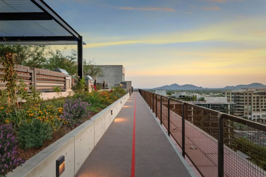 A clay running track on the rooftop of an urban apartment building