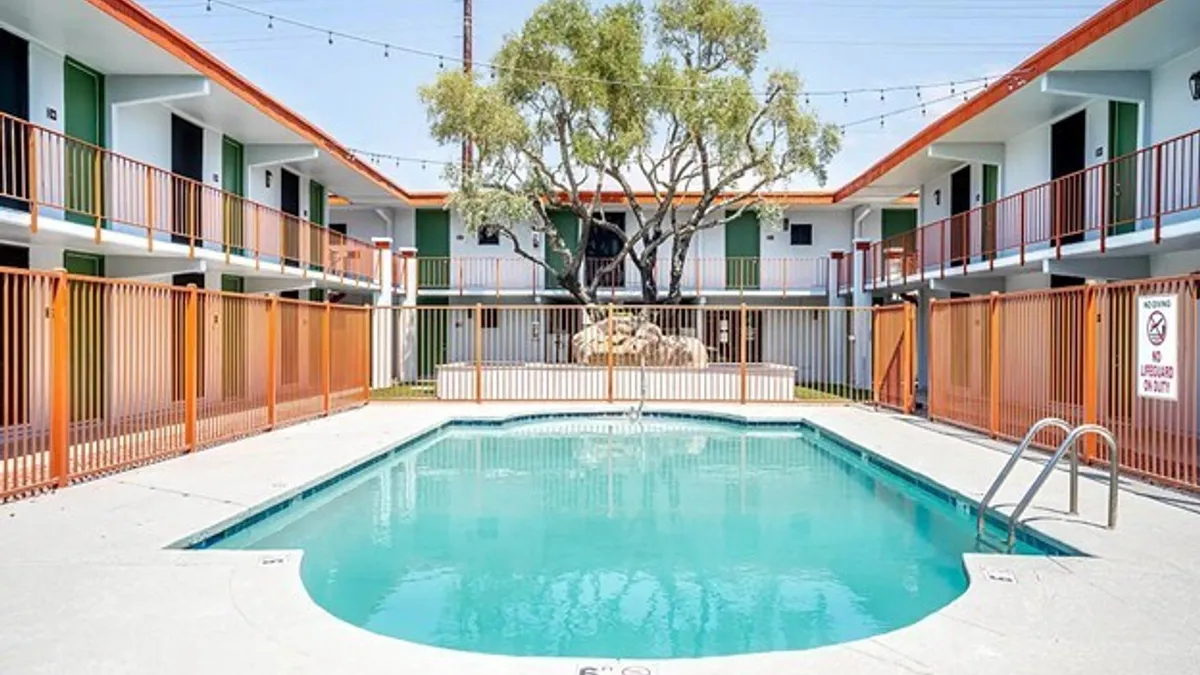 Pool surrounded by older apartment building